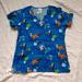 Disney Tops | Disney Nursing Uniform Smock Scrubs Scrub Top | Color: Blue/White | Size: Xs