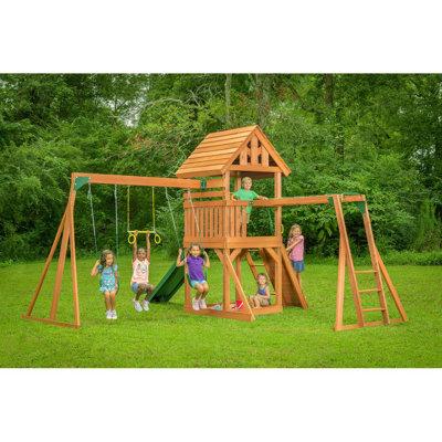 Creative Cedar Designs Mountain View Lodge Playset W/Wooden Roof & Green Slide Swing Set Wooden/ in Brown | 120 H x 176 W x 218 D in | Wayfair