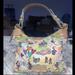 Dooney & Bourke Bags | Dooney & Bourke Disney Rare Erica Sketch Champsac Pocketbook | Color: Purple/Yellow | Size: Os