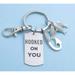 Hooked on you keychain in stainless steel. The words Hooked On You are printed on a dog tag and include a fish hook and three little fish.