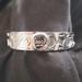 Coach Jewelry | Gently Worn Coach Silver Bangle Bracelet With "C" Logo All Over. | Color: Silver | Size: Os
