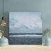 Rosecliff Heights A Bird Far Away Flying Over The Beach Under Gray Sky - 1 Piece Rectangle Graphic Art Print On Wrapped Canvas in White | Wayfair