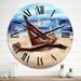 Designart 'An Old Fishing Boat On The Sandy Beach' Nautical & Coastal wall clock