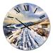 Designart 'Snowy Road Through Winter Landscape I' Country wall clock