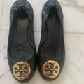 Tory Burch Shoes | Black Leather With Gold Emblem. Well Loved-Scratches & Scuffs To Toe And Heel. | Color: Black/Gold | Size: 7.5