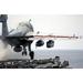 Airman ducks down as an EA-6B Prowler launches from the flight deck aboard USS Ronald Reagan Poster Print by Stocktrek Images (34 x 22)