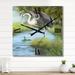 Designart 'Crane Hunting A Frog In The Water' Farmhouse Large Wall Clock