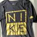 Nike Shirts | Black & Gold Nike Name Logo Graphic Short Sleeved Tshirt Size Small - Genuine | Color: Black | Size: S