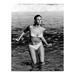 Raquel Welch Posing in a Bikini - Unframed Photograph Paper in Black/White Globe Photos Entertainment & Media | 20 H x 16 W x 1 D in | Wayfair