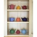 Antique ceramic teapots and sugar bowls in cupboard by Steve Terrill (24 x 36)