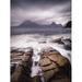 Sea flowing into a channel in the rocks as waves come in and out leading to the Black Cullin mountains across the bay. Poster Print by Loop Images Ltd. (12 x 16)