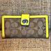 Coach Bags | Coach Legacy Signature Slim Turn Lock Closure Trifold Wallet Neon Yellow Trim | Color: Cream/Yellow | Size: Os