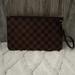 Louis Vuitton Bags | Authentic Louis Vuitton Damier Ebene Neverfull Wristlet New | Color: Brown | Size: Os