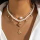 PuRui Collana con ciondolo a forma di stella marina color oro, perle d'imitazione, girocollo per