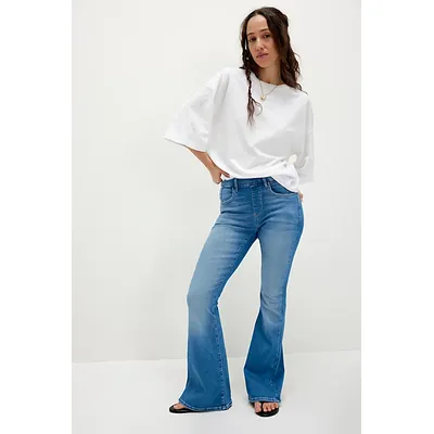 CRVY Infinite Stretch Pull-On Flare Jeans by We The Free at Free People in Mid Indigo, Size: XS