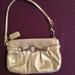 Coach Bags | Coach Wristlet W/ Coach Chain Tag & Silver Decorative Hardware In Gold | Color: Gold | Size: 7” X 4 1/2”