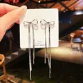 Boucles d'oreilles pendantes à long pompon en acier inoxydable pour femmes nœud papillon ruban de