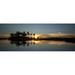 Sun setting over a body of water at the Selinda Reserve; Selinda Reserve Botswana Poster Print by Michael Melford (23 x 8)