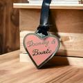 Dooney & Bourke Accessories | Dooney & Bourke Brass Heart Medallion Black Leather Cord Bag Charm Accessory | Color: Gold/Pink | Size: Os