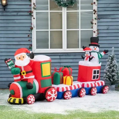 Santa Claus, Snowman and Penguin carry gift boxes on train inflatables, putting together a cohesive