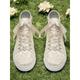 Women's Ivory Lace Wedding Sneakers with Satin Ribbon Laces and Rhinestone Heart Charm – Comfortable Bridal Shoes for Weddings