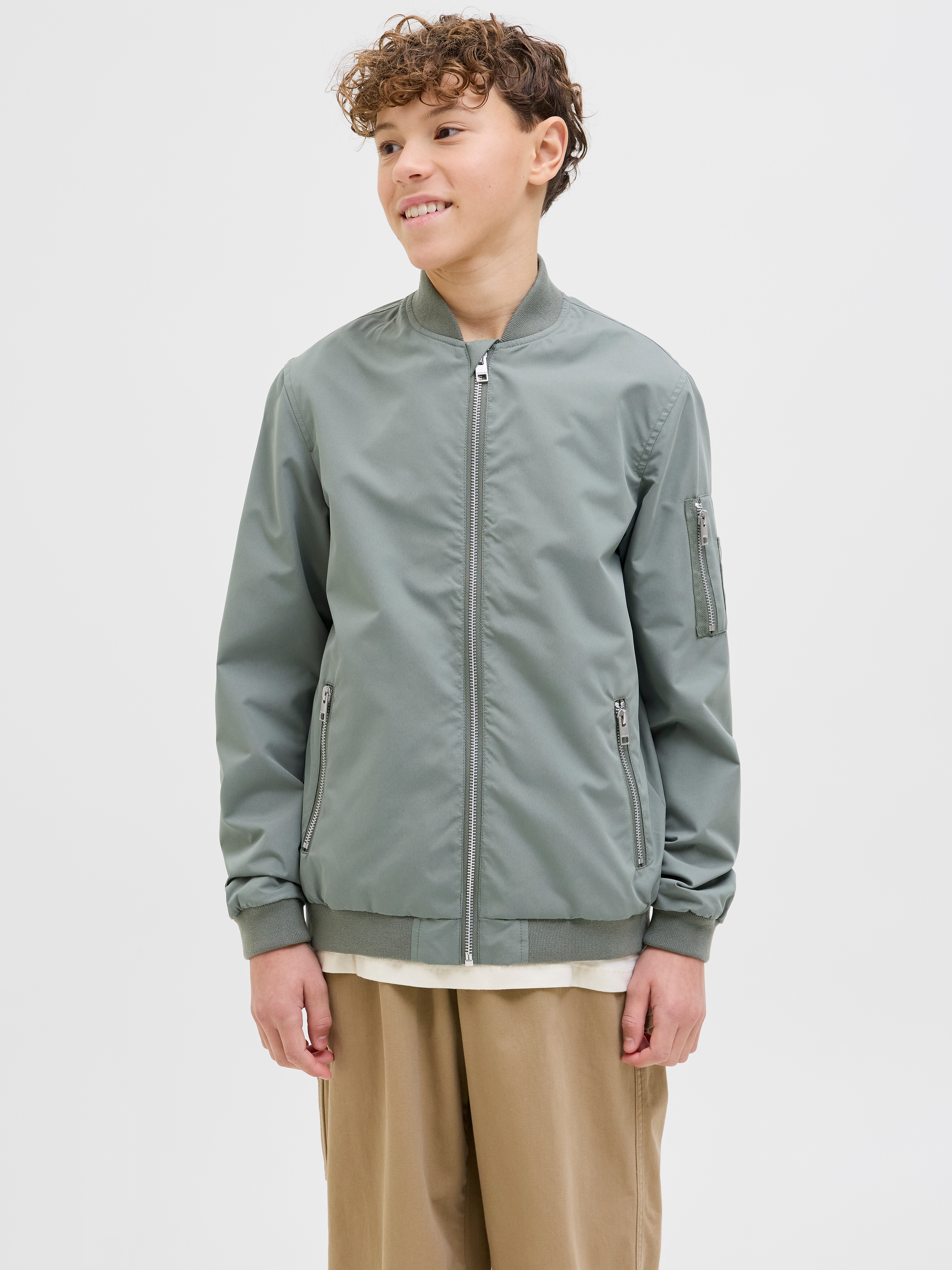 Bomberjacke JACK & JONES JUNIOR "JJERUSH windabweisend und pflegeleicht", Jungen, Gr. 140, grün (agave grün), Web, Obermaterial: 100% Polyester, unifarben, normal, Bündchen, Jacken Bomberjacke, unifarben, modisch, regular fit, Web, Stehkragen