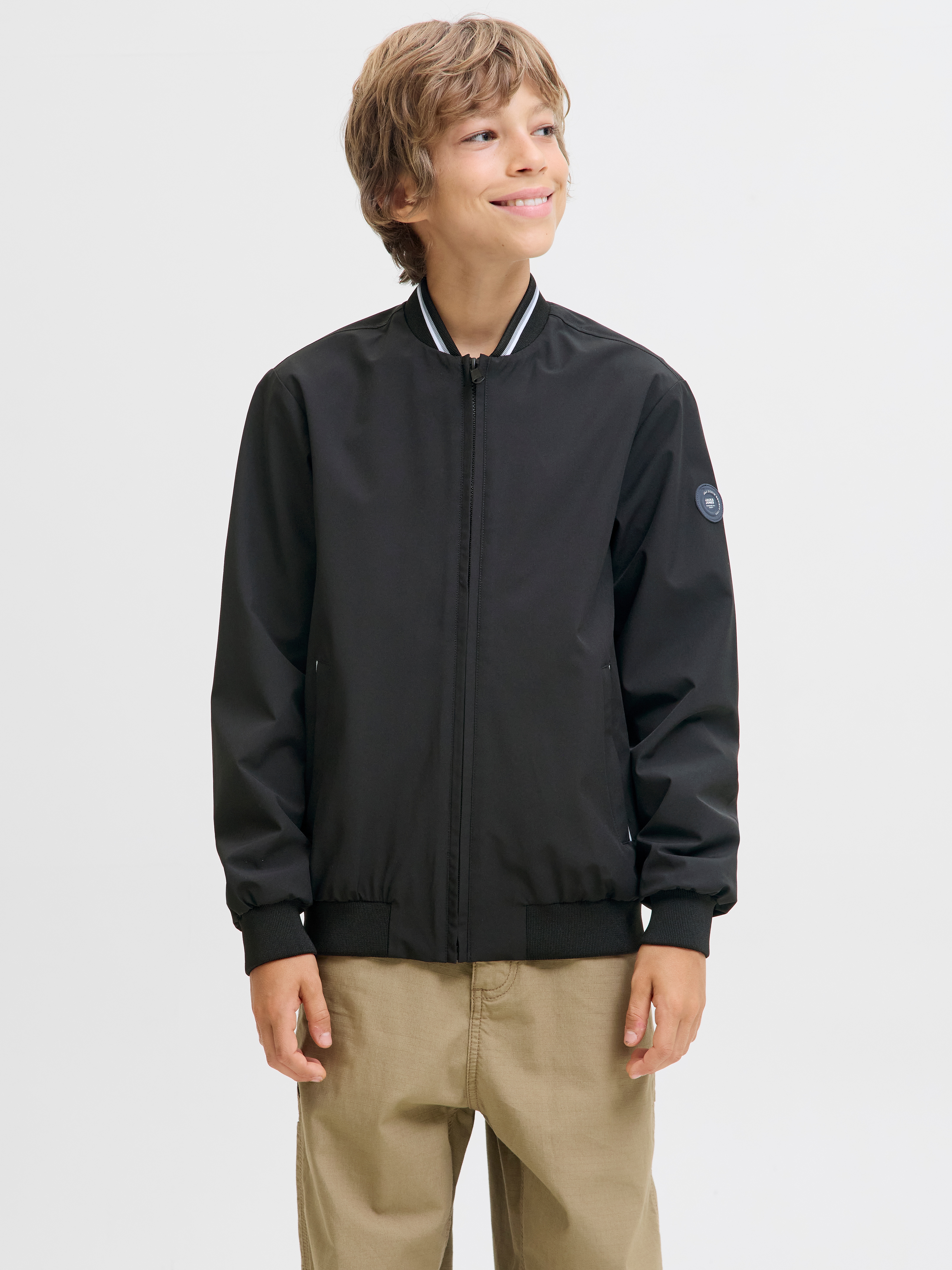 Bomberjacke JACK & JONES JUNIOR "JJBROOK BOMBER JNR", Jungen, Gr. 140, schwarz (schwarz detail:lining: schwarz), Web, Obermaterial: 90% Polyester, 10% Elasthan, unifarben, regular fit normal, Jacken Bomberjacke