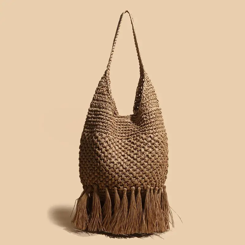 Mode française nouveau évidé tissé gland à la main herbe tissé sac à bandoulière nouvel été Simple mode décontracté sac de plage à la mode