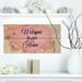 East Urban Home Welcome to Our Home. Floral Heart - Textual Art on Wood in Blue/Brown/Pink | 10 H x 20 W x 0.78 D in | Wayfair