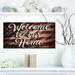 East Urban Home 'Welcome to Our Home. American Flag' Textual Art on Wood in Brown/Gray | 10 H x 20 W x 0.78 D in | Wayfair